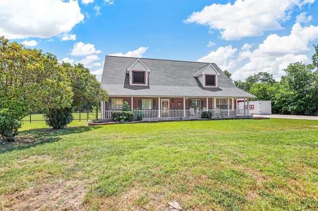 Cape cod house featuring a front lawn and a porch | Image 4