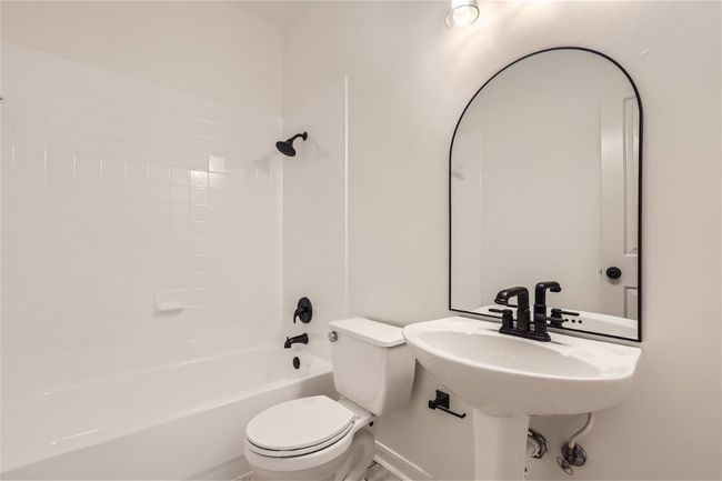 Bathroom featuring toilet and shower / tub combination | Image 25