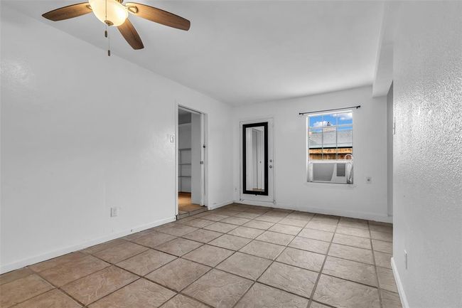 The family room offers direct access to the pantry, and the closed door leads out to the backyard. | Image 16