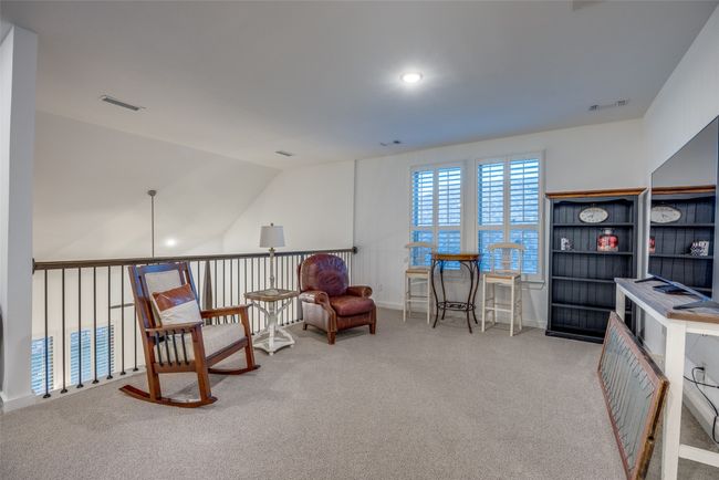 Living area featuring carpet, visible vents, and vaulted ceiling | Image 19
