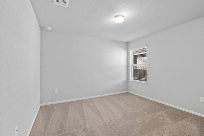 Carpeted empty room with visible vents, baseboards, and a textured ceiling | Image 19