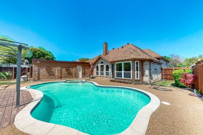 View of swimming pool featuring a fenced in pool, a patio area, and a fenced backyard | Image 40