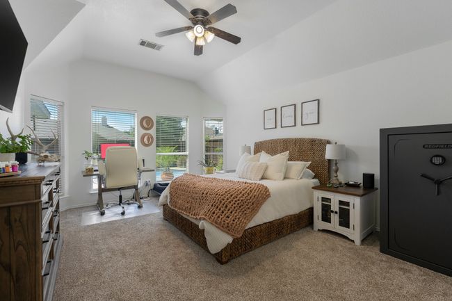 Bedroom featuring lofted ceiling, light colored carpet, a desk, and ceiling fan | Image 20