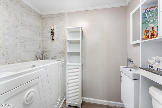 Full bathroom with wood finished floors, crown molding, and baseboards | Image 26