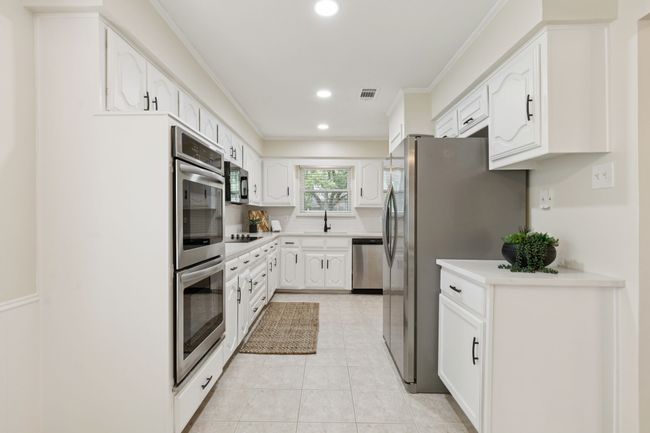 Newly updated kitchen with new quartz countertops, new backsplash, new disposal, fresh paint, double ovens, new sink and faucet, new lighting, dishwasher, built-in cooktop, built-in microwave, and double door stainless refrigerator | Image 4