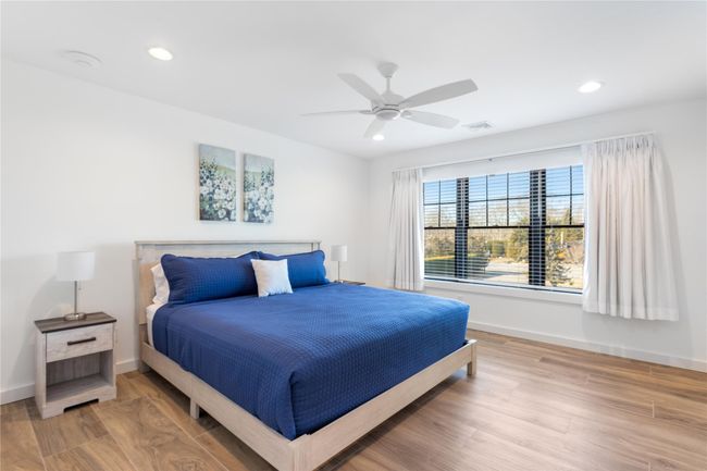 Bedroom featuring visible vents, baseboards, and wood finished floors | Image 9