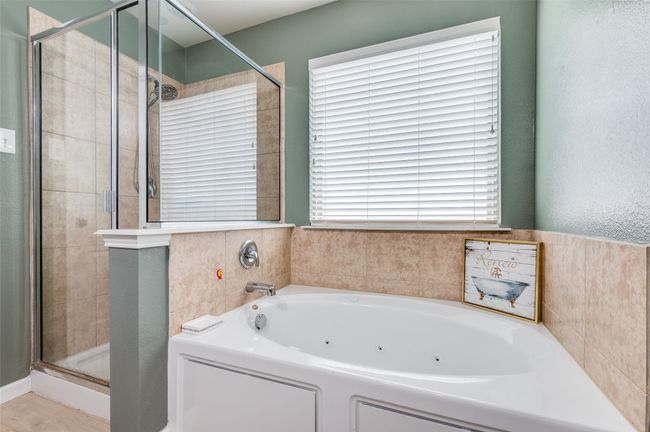 Primary Bath featuring a jetted tub and a separate stall shower. | Image 32