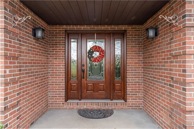 Covered front entry with detailed brick, quoin corners | Image 5
