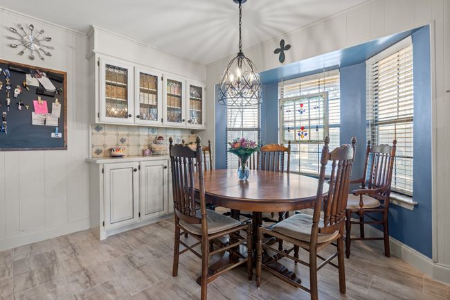 Dining space with light hardwood / wood-style flooring and a chandelier | Image 16