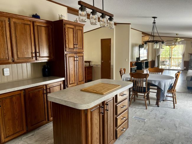 Plenty of cabinets, counter space, and convenience with an island in your bright, open kitchen. | Image 10