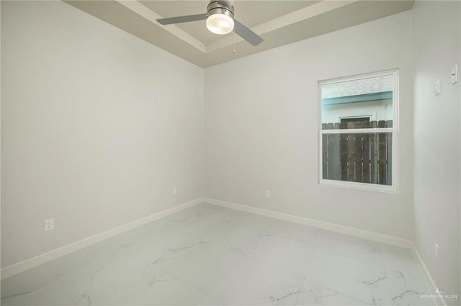 Unfurnished room with baseboards, light marble finish floors, and a ceiling fan | Image 12