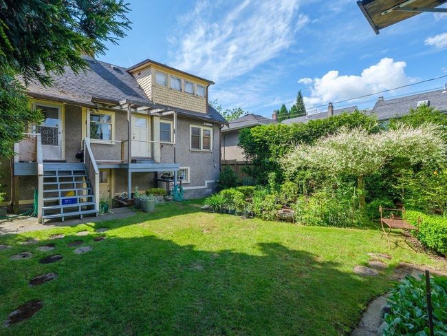 View of green lawn featuring stairway and a wooden deck | Image 18