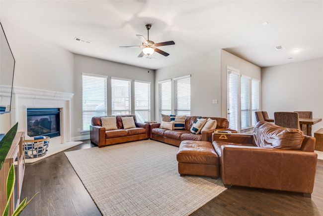 Entrance foyer featuring ceiling fan, arched walkways, high vaulted ceiling, wood finished floors, and stairway | Image 4