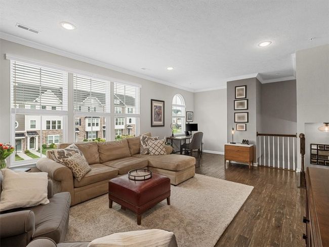 stunning great room offers a perfect blend of style, space, and functionality. Bathed in natural light from a wall of oversized windows, the open layout features rich hardwood flooring and recessed lighting for a bright, welcoming​​‌​​​​‌​​‌‌​‌‌​​​‌‌​​‌‌​‌​​​​​‌ atmosphere. | Image 12