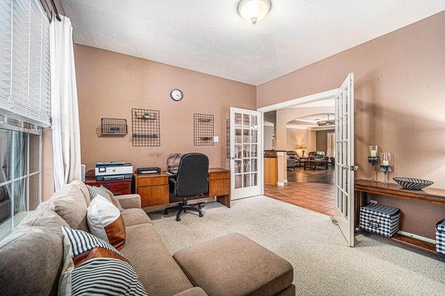This versatile flex room, complete with French doors and natural light, is perfect for a home office, playroom, or cozy reading nook. | Image 17