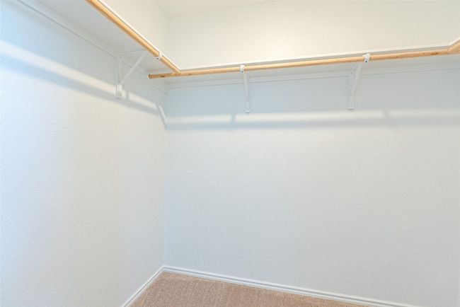 Spacious closet with carpet flooring | Image 12