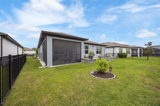 Backyard with manicured lawn and trees | Image 31