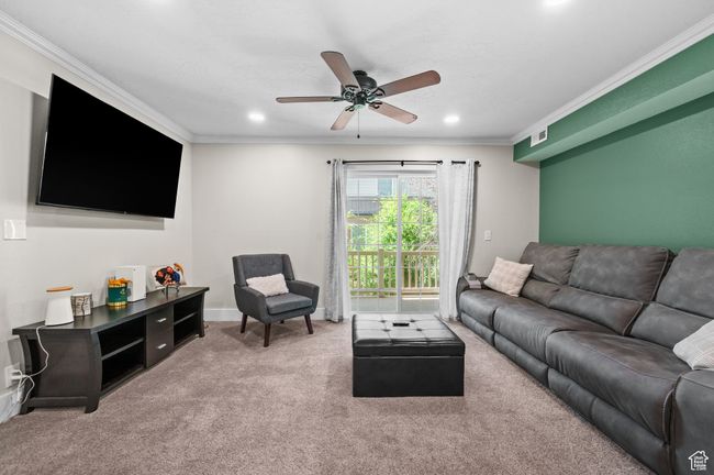Living room with ornamental molding, carpet flooring, ceiling fan, and recessed lighting | Image 4