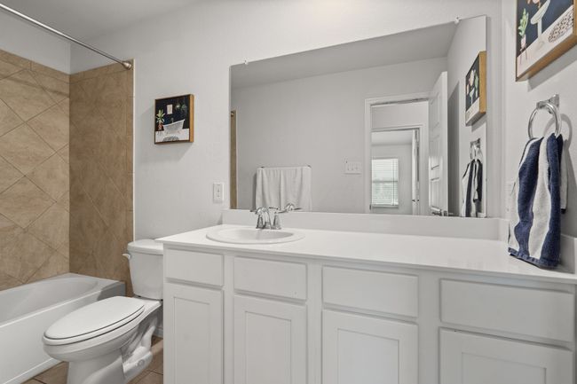 Bathroom featuring toilet, vanity, and tub / shower combination | Image 30