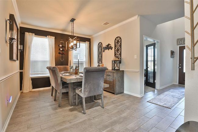 The primary living area downstairs features tile flooring throughout, offering both durability and easy maintenance for a clean and accessible space. | Image 6