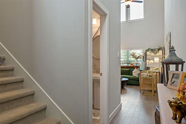 Stairs featuring ceiling fan, wood-type flooring, and a high ceiling | Image 4