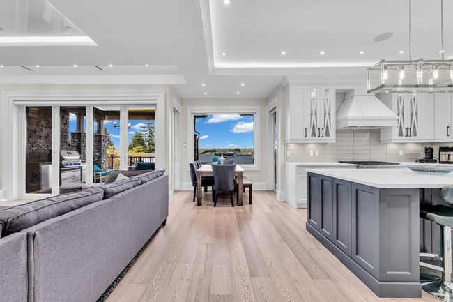 Living room with recessed lighting, light wood-style floors, and a raised ceiling | Image 22