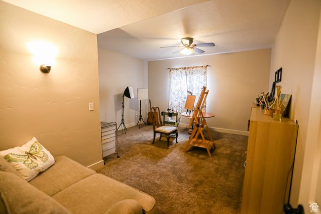 Living room featuring a ceiling fan, carpet floors, and baseboards | Image 52