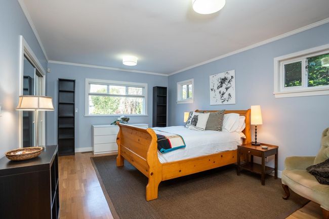 Bedroom with ornamental molding, baseboards, and wood finished floors | Image 15