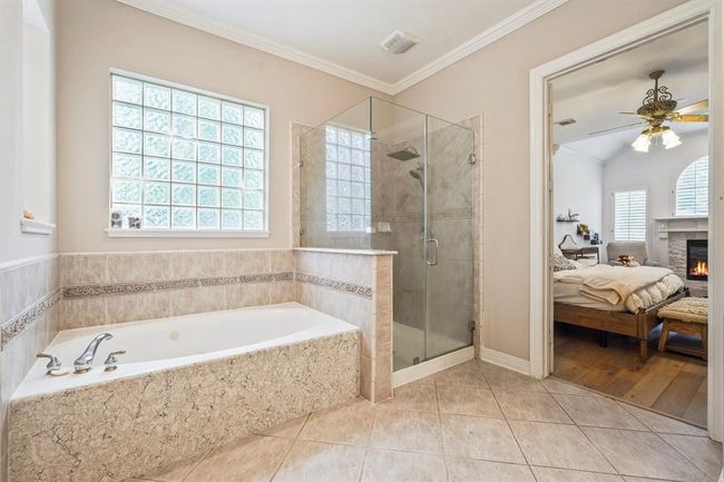 Master bathroom featuring a soaking tub and frameless shower. | Image 15