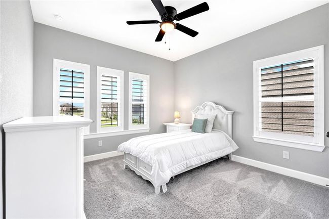 Secondary bedroom with plantation shutters and walk in closet | Image 41