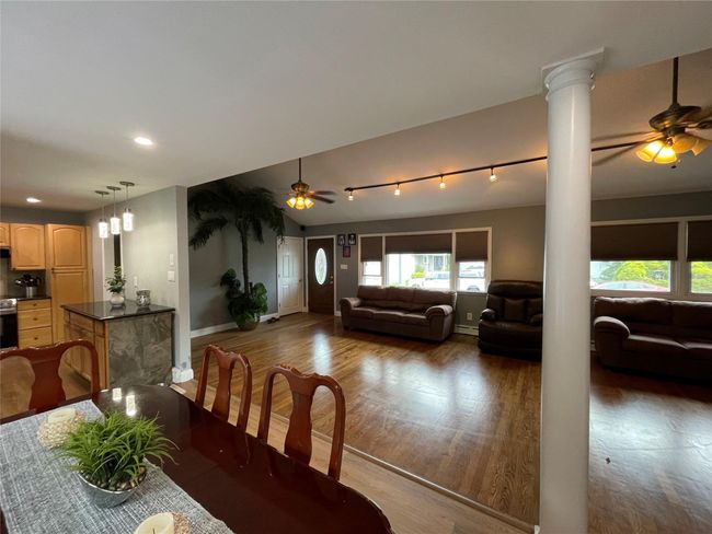 Dining area with ornate columns, a ceiling fan, wood finished floors, and recessed lighting | Image 13
