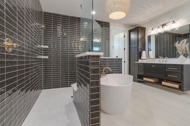 Bathroom featuring tile patterned flooring, shower with separate bathtub, vanity, and tile walls | Image 19