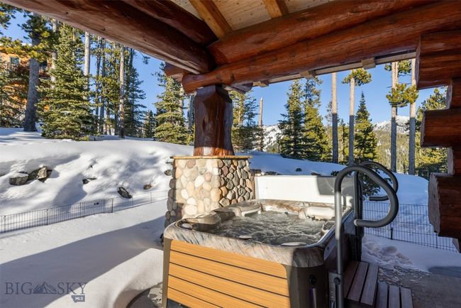North side patio off of Primary Suite, with hot tub and rock retaining wall. | Image 70