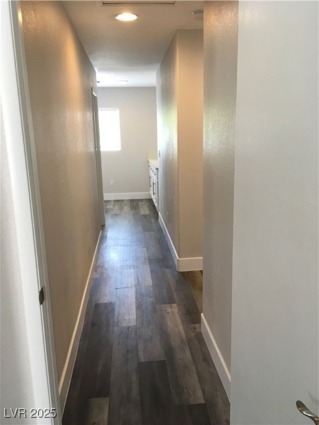 Hallway with baseboards and dark wood-style flooring | Image 17