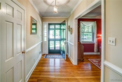 Entrance foyer with a wealth of natural light, crown molding, and hardwood floors | Image 3