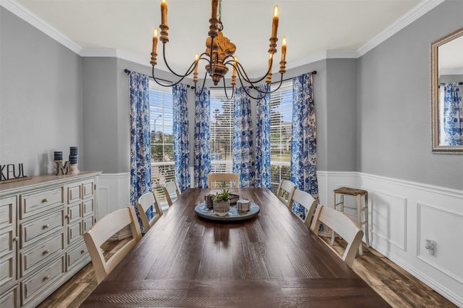 Dining room with hardwood / wood-style flooring, a chandelier, and crown molding | Image 4