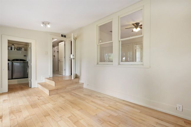 Empty room with washing machine and dryer, wood finished floors, and a ceiling fan | Image 22