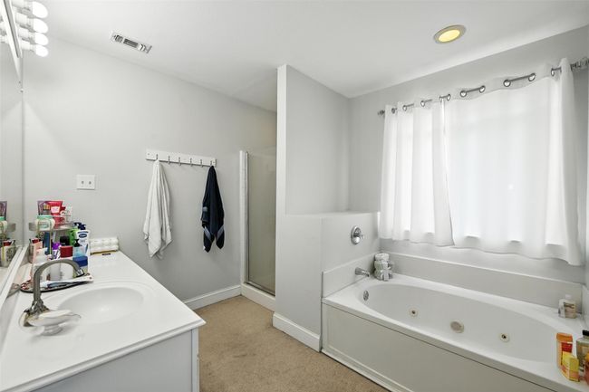 Full bathroom featuring a jetted tub, double vanity, and a stall shower | Image 24