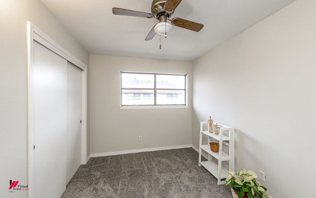 Unfurnished bedroom with a ceiling fan, carpet, a closet, and baseboards | Image 22