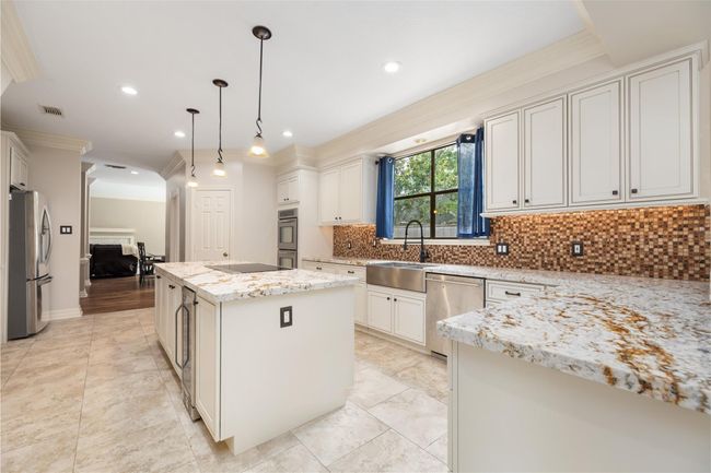 With its deep farm sink, generous counter space, and smart layout, this kitchen is made for real life—offering room to prep, clean, and connect all in one inviting space. | Image 18