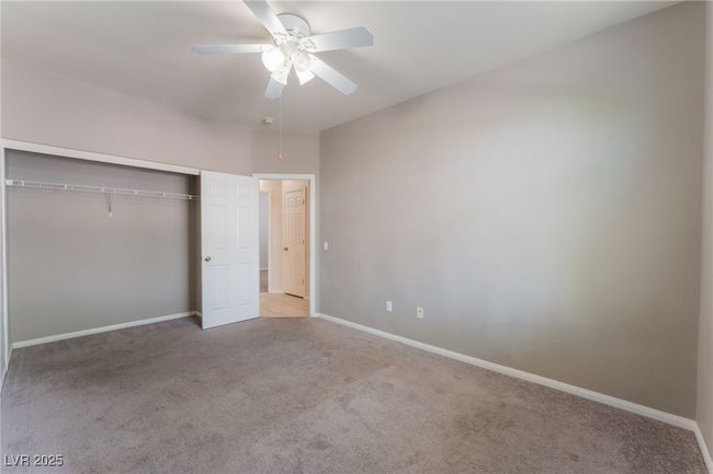 Unfurnished bedroom featuring carpet, a closet, baseboards, and a ceiling fan | Image 40