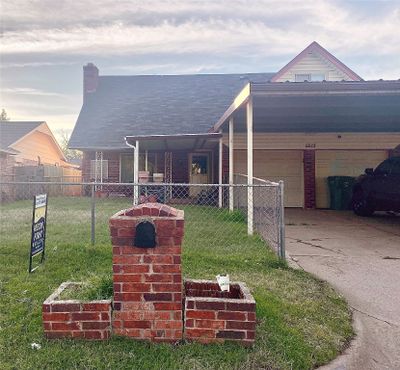 Front of house featuring a lawn, brick mailbox and covered carport | Image 1