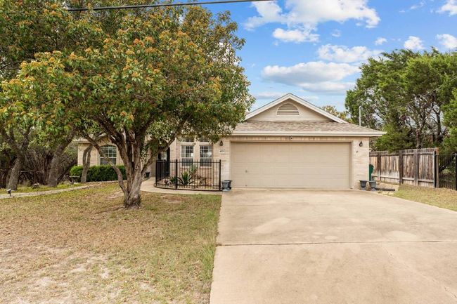 View of front of home featuring roof with shingles, concrete driveway, fence, brick siding, and an attached garage | Image 13