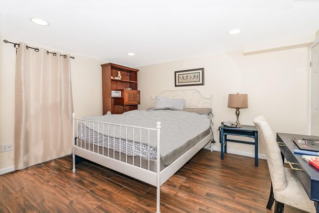 Bedroom featuring wood finished floors, recessed lighting, and baseboards | Image 10