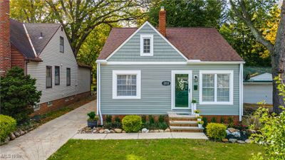 View of front facade featuring a garage, an outbuilding, and a front lawn | Image 2