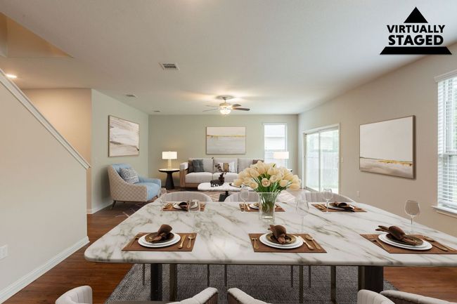 Dining area with dark wood-style flooring, a ceiling fan, baseboards, and plenty of natural light | Image 8