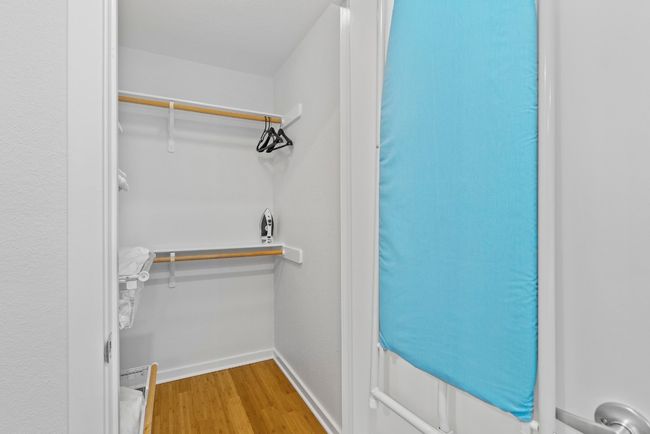 Walk in closet with wood finished floors | Image 19