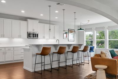 Fabulous entertainer's open floor plan with the contemporary kitchen and sunny breakfast area overlooking the living room through a wide sweeping archway. | Image 3