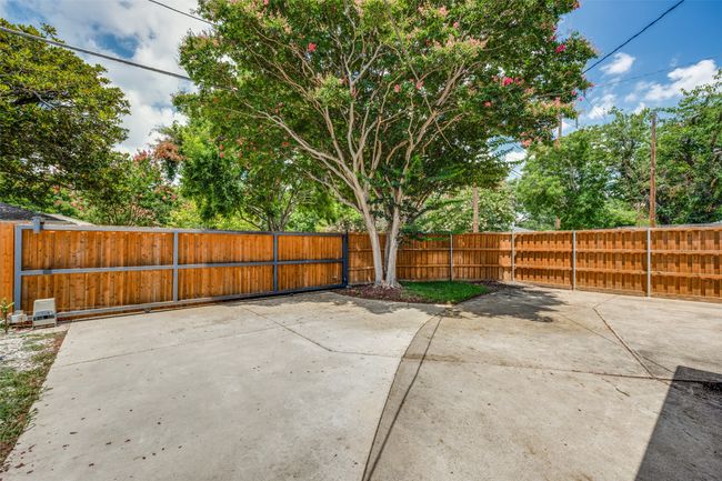 Security gate at back driveway. Lots of extra parking for guests. Carport for owner. | Image 22