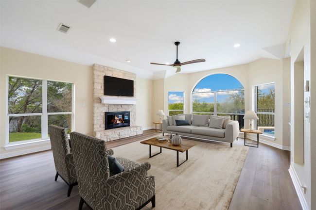 View of den featuring 2nd fireplace and ceiling fan | Image 11